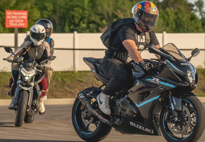 Greg on a motorcycle with another motorcycle behind him