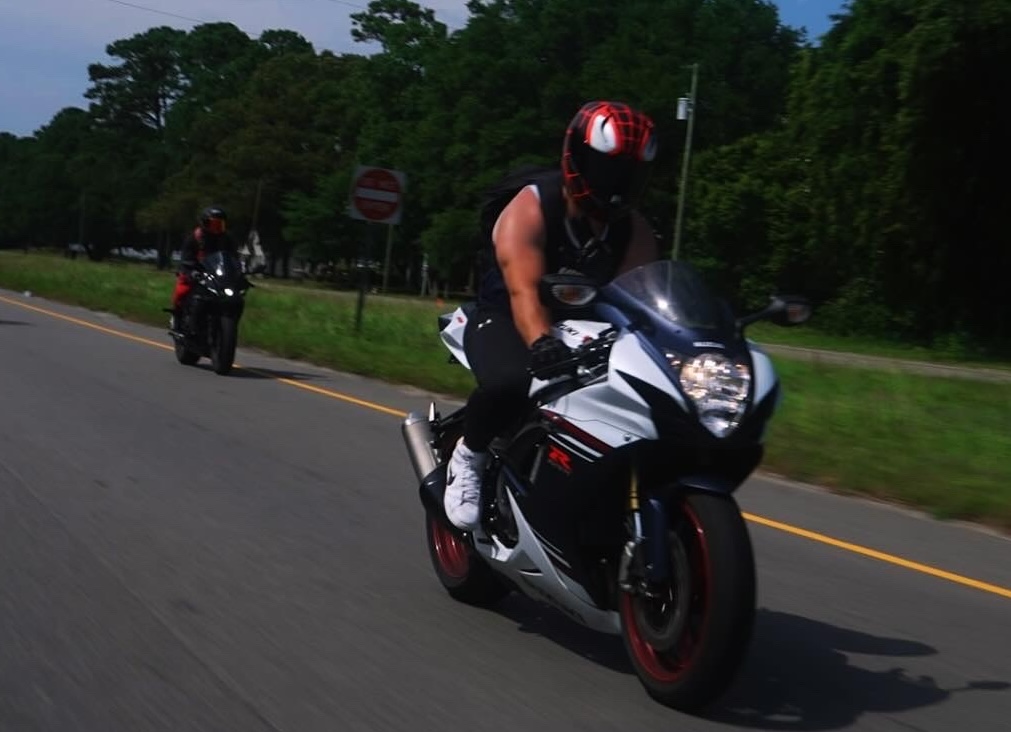 Greg riding his motorcycle on the road